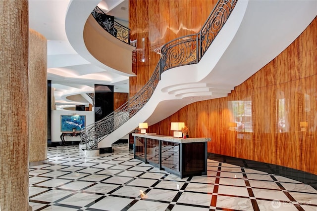 1920 4th Ave Unit 1105, Seattle, WA 98101 - common area featuring wooden walls, stairway, and a towering ceiling