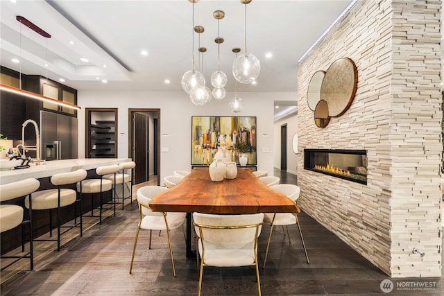 11210 SE 74th St, Newcastle, WA 98056 - dining area with a fireplace, recessed lighting, and dark wood finished floors