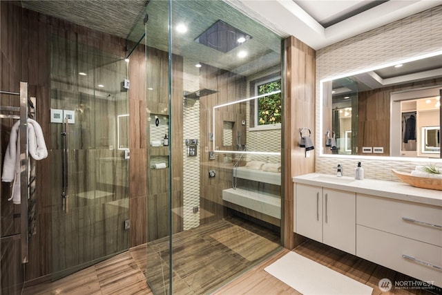 11210 SE 74th St, Newcastle, WA 98056 - full bath featuring vanity, a shower stall, tasteful backsplash, and wood finished floors