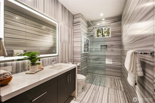 11210 SE 74th St, Newcastle, WA 98056 - full bath featuring vanity, tile patterned floors, a walk in shower, and tile walls