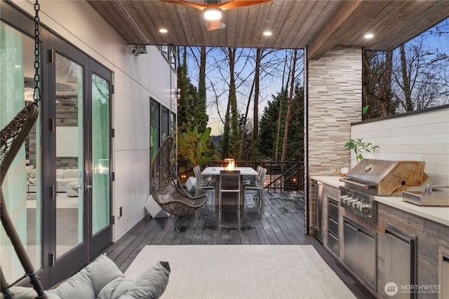 11210 SE 74th St, Newcastle, WA 98056 - wooden deck with an outdoor kitchen and outdoor dining space