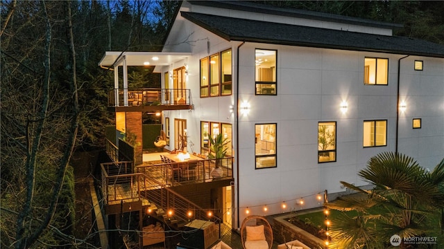 11210 SE 74th St, Newcastle, WA 98056 - property exterior at twilight featuring a balcony and stairway