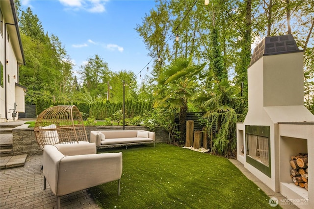 11210 SE 74th St, Newcastle, WA 98056 - fenced backyard featuring a patio, an outdoor living space with a fireplace, and view of wooded area