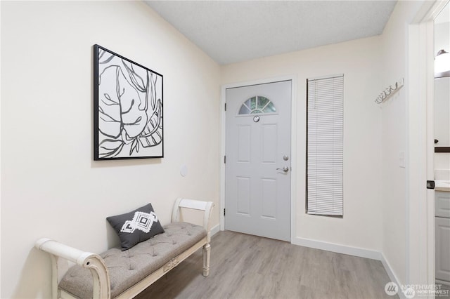 13838 NE 60th St Unit 165, Redmond, WA 98052 - foyer entrance with light wood-style flooring and baseboards