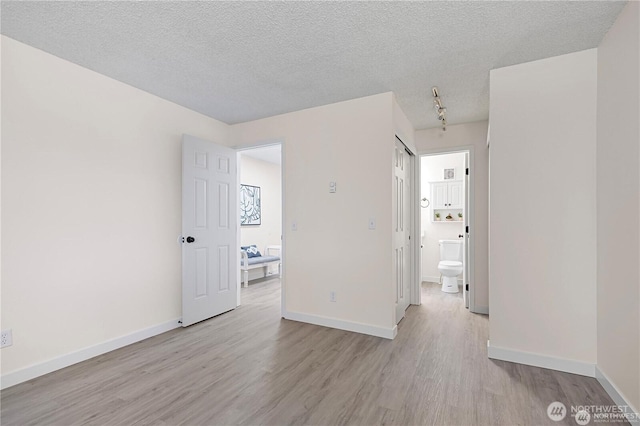 13838 NE 60th St Unit 165, Redmond, WA 98052 - unfurnished room with light wood-style flooring and a textured ceiling