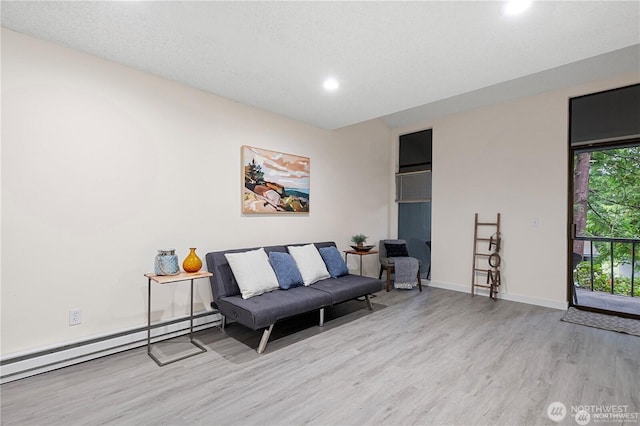 13838 NE 60th St Unit 165, Redmond, WA 98052 - living room with a baseboard radiator, wood finished floors, and recessed lighting