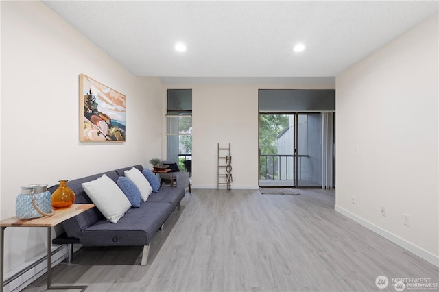 13838 NE 60th St Unit 165, Redmond, WA 98052 - living room featuring wood finished floors, recessed lighting, and a baseboard radiator