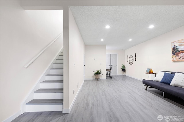 13838 NE 60th St Unit 165, Redmond, WA 98052 - living area featuring stairs, recessed lighting, wood finished floors, and a textured ceiling