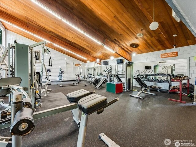 13838 NE 60th St Unit 165, Redmond, WA 98052 - gym with vaulted ceiling, wooden ceiling, and brick wall