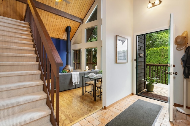 26639 NE Stewart St, Duvall, WA 98019 - entrance foyer featuring a wood ceiling with exposed beams, high vaulted ceiling, stairs, and a wood stove