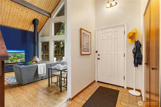 26639 NE Stewart St, Duvall, WA 98019 - entrance foyer featuring high vaulted ceiling, a wood stove, and a wooden ceiling with exposed beams