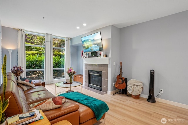 3221 SW Avalon Way Unit 113, Seattle, WA 98126 - living area with a tiled fireplace, recessed lighting, and wood finished floors