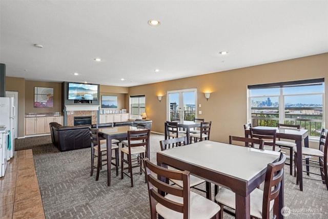 3221 SW Avalon Way Unit 113, Seattle, WA 98126 - dining room featuring a glass covered fireplace, recessed lighting, and carpet
