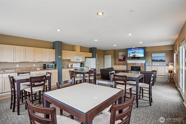 3221 SW Avalon Way Unit 113, Seattle, WA 98126 - carpeted dining area featuring a fireplace and recessed lighting