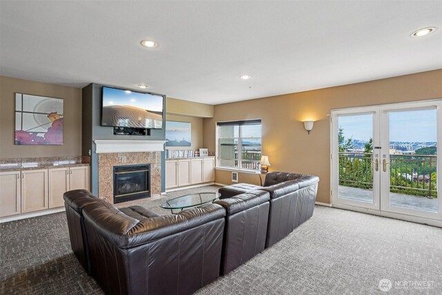 3221 SW Avalon Way Unit 113, Seattle, WA 98126 - carpeted living room with recessed lighting, a tiled fireplace, and french doors