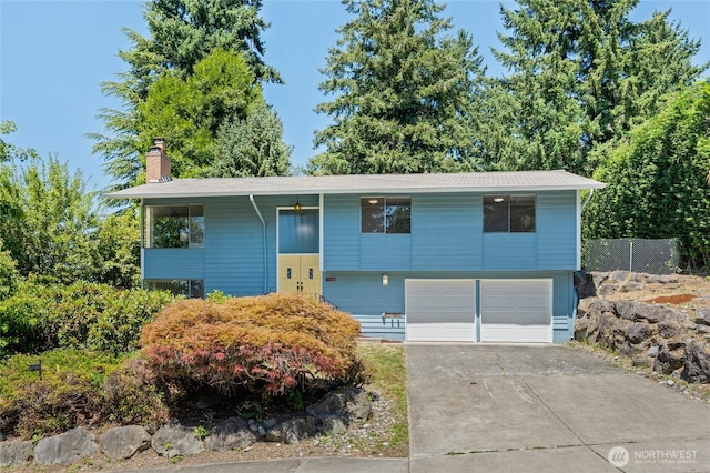 13726 SE 24th St, Bellevue, WA 98005 - bi-level home featuring an attached garage, a chimney, and driveway