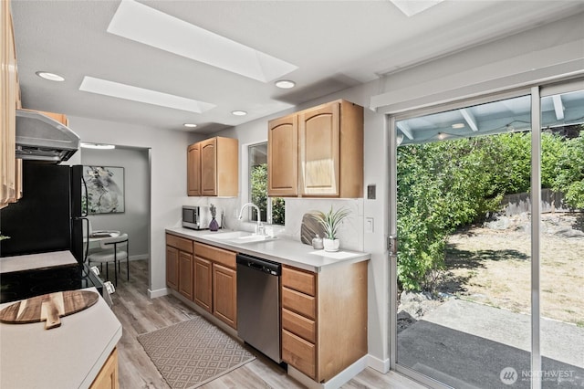 13726 SE 24th St, Bellevue, WA 98005 - kitchen with ventilation hood, stainless steel appliances, a skylight, light wood-type flooring, and light countertops