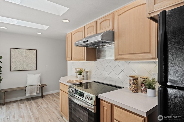 13726 SE 24th St, Bellevue, WA 98005 - kitchen with freestanding refrigerator, stainless steel electric range, under cabinet range hood, light brown cabinetry, and a skylight