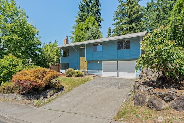 13726 SE 24th St, Bellevue, WA 98005 - raised ranch featuring a chimney, an attached garage, driveway, and a porch