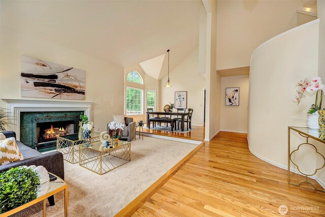 5044 157th Ct NE, Redmond, WA 98052 - living area with light wood-style floors, a fireplace, and high vaulted ceiling