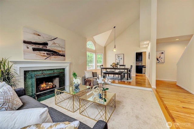 5044 157th Ct NE, Redmond, WA 98052 - living room with wood finished floors, a high end fireplace, and high vaulted ceiling