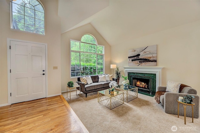 5044 157th Ct NE, Redmond, WA 98052 - living room featuring high vaulted ceiling, a high end fireplace, and wood finished floors