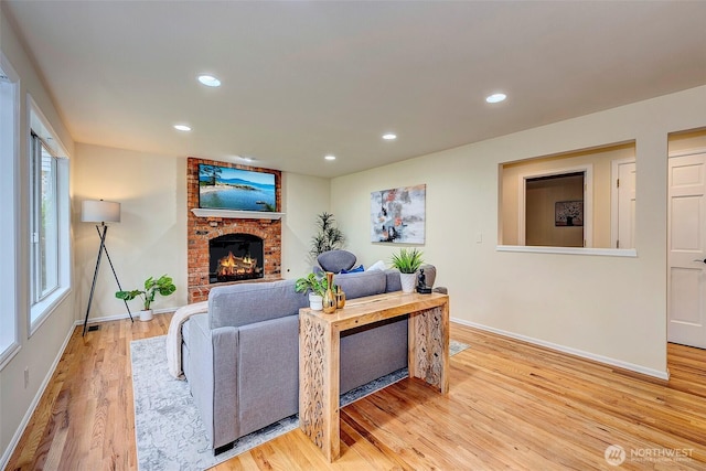 5044 157th Ct NE, Redmond, WA 98052 - living area with light wood-style flooring, a brick fireplace, and recessed lighting