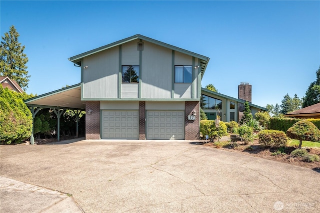 17 Jeffery Pl, Longview, WA 98632 - view of front of house featuring brick siding, a garage, concrete driveway, and a carport