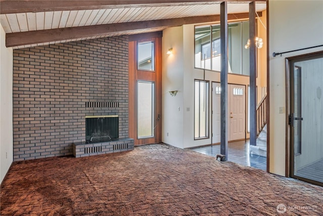 17 Jeffery Pl, Longview, WA 98632 - unfurnished living room with carpet floors, a brick fireplace, a wood ceiling with exposed beams, high vaulted ceiling, and stairway