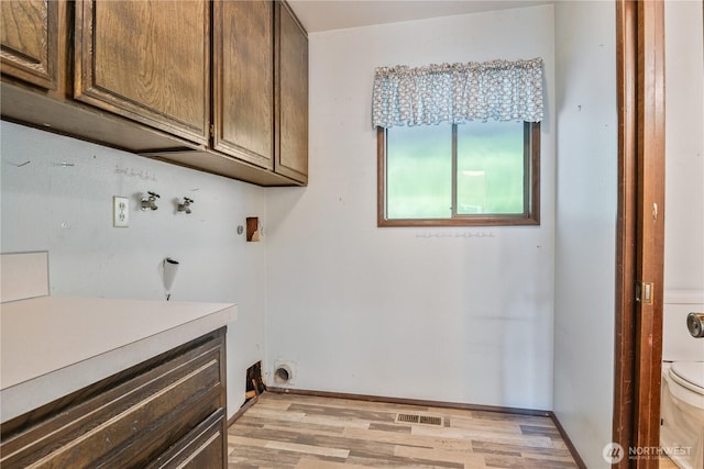 17 Jeffery Pl, Longview, WA 98632 - laundry room with cabinet space, light wood-type flooring, and washer hookup