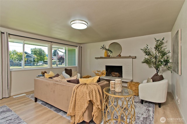 1136 Harding, Enumclaw, WA 98022 - living area with light wood-style floors and a brick fireplace