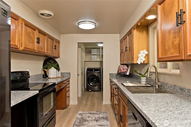 1136 Harding, Enumclaw, WA 98022 - kitchen featuring black appliances, washer / dryer, brown cabinets, and light wood-style floors