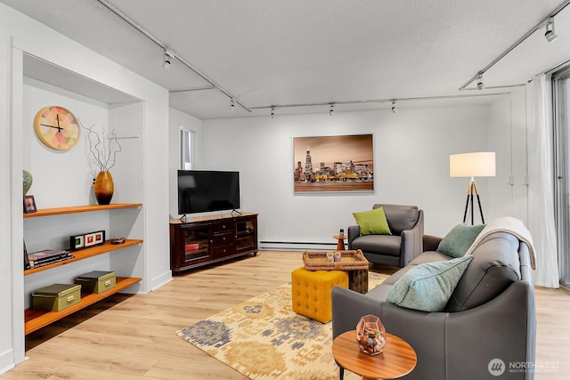 4540 8th Ave NE Unit 202, Seattle, WA 98105 - living area featuring track lighting, baseboard heating, and wood finished floors