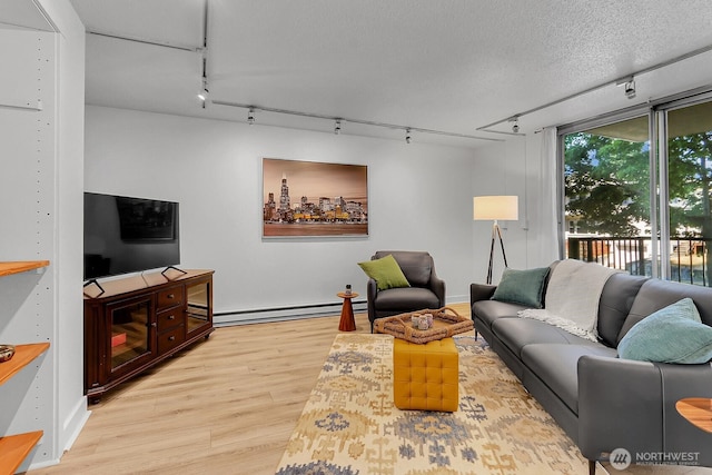 4540 8th Ave NE Unit 202, Seattle, WA 98105 - living room with track lighting, baseboard heating, and light wood-style flooring