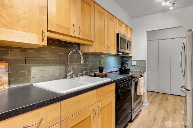 4540 8th Ave NE Unit 202, Seattle, WA 98105 - kitchen with appliances with stainless steel finishes, light wood-type flooring, dark countertops, light brown cabinets, and tasteful backsplash