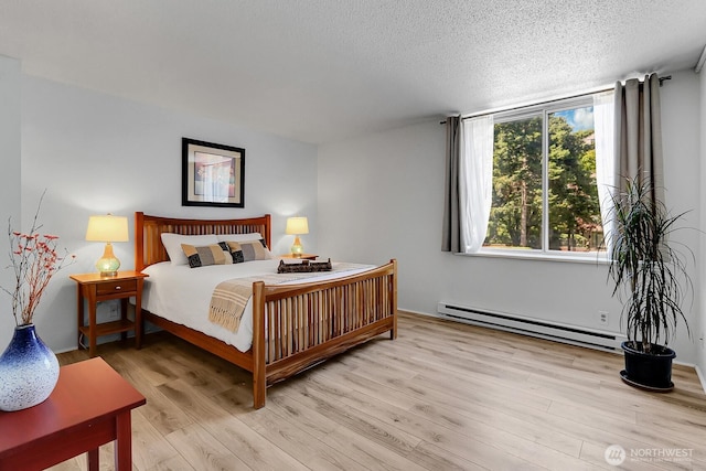 4540 8th Ave NE Unit 202, Seattle, WA 98105 - bedroom with baseboard heating, light wood-type flooring, and a textured ceiling
