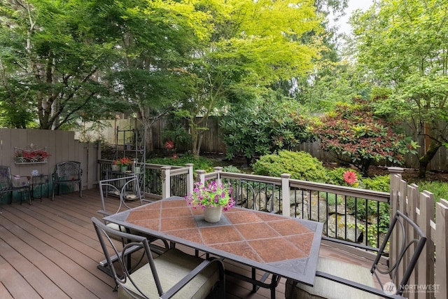 23430 100th Ave SE Unit E102, Kent, WA 98031 - wooden deck with outdoor dining area and a fenced backyard