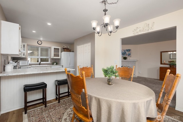 23430 100th Ave SE Unit E102, Kent, WA 98031 - dining area featuring a chandelier, wood finished floors, and recessed lighting