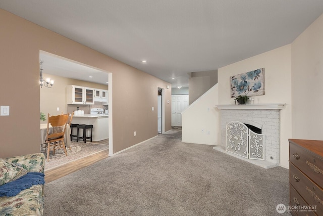 23430 100th Ave SE Unit E102, Kent, WA 98031 - carpeted living area with a fireplace, recessed lighting, and a chandelier