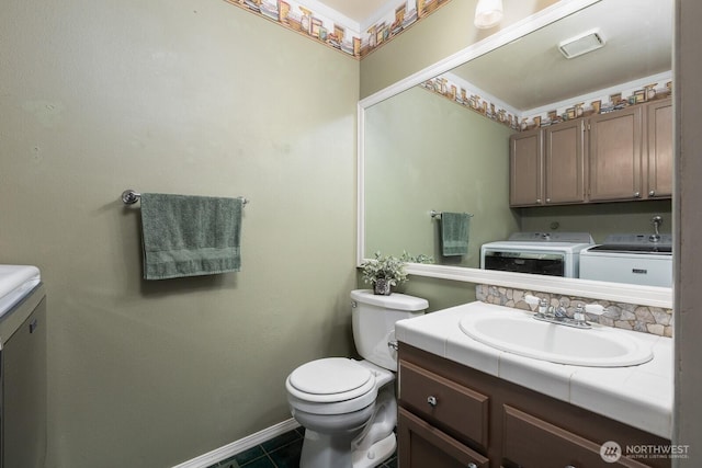 23430 100th Ave SE Unit E102, Kent, WA 98031 - bathroom with washer and clothes dryer, vanity, and tile patterned floors