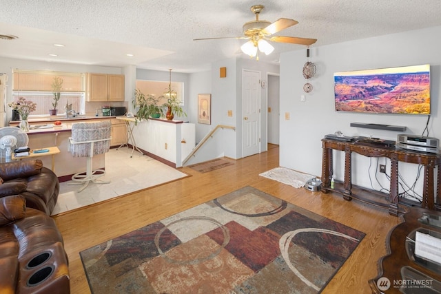 3235 33rd Ave S, Seattle, WA 98144 - living area featuring a textured ceiling, light wood-style floors, a ceiling fan, and recessed lighting