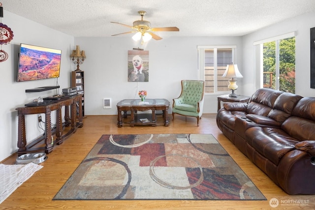 3235 33rd Ave S, Seattle, WA 98144 - living room featuring wood finished floors, a textured ceiling, and ceiling fan