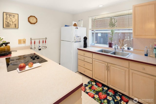 3235 33rd Ave S, Seattle, WA 98144 - kitchen with freestanding refrigerator, black electric stovetop, light brown cabinetry, and light countertops