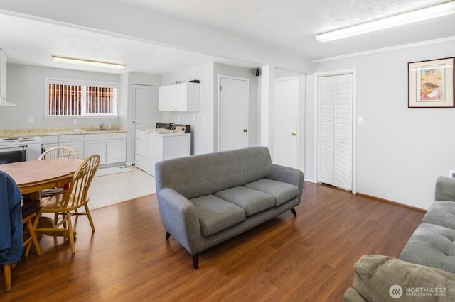 3235 33rd Ave S, Seattle, WA 98144 - living room featuring wood finished floors and washing machine and clothes dryer