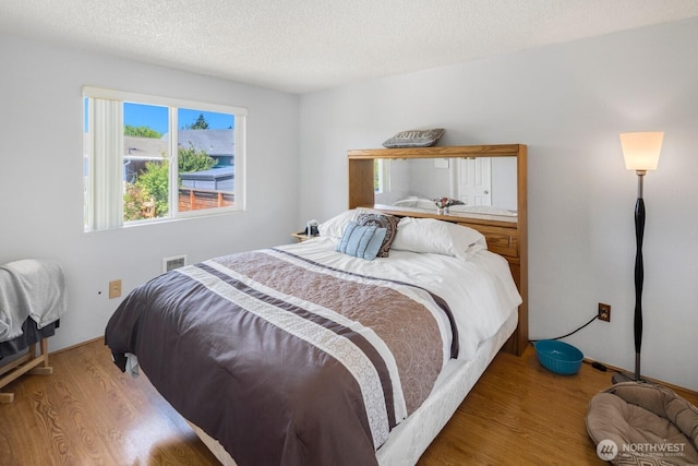 3235 33rd Ave S, Seattle, WA 98144 - bedroom with wood finished floors and a textured ceiling