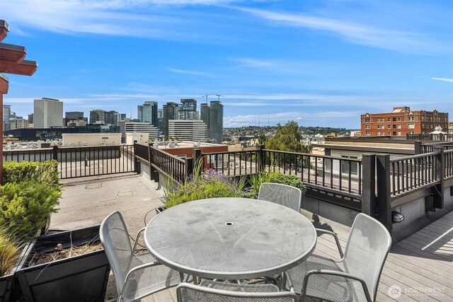1610 Belmont Ave Unit 314, Seattle, WA 98122 - wooden terrace featuring a view of skyline and outdoor dining area