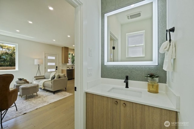 12046 5th Ave NE, Seattle, WA 98125 - bathroom with wood finished floors, vanity, and recessed lighting