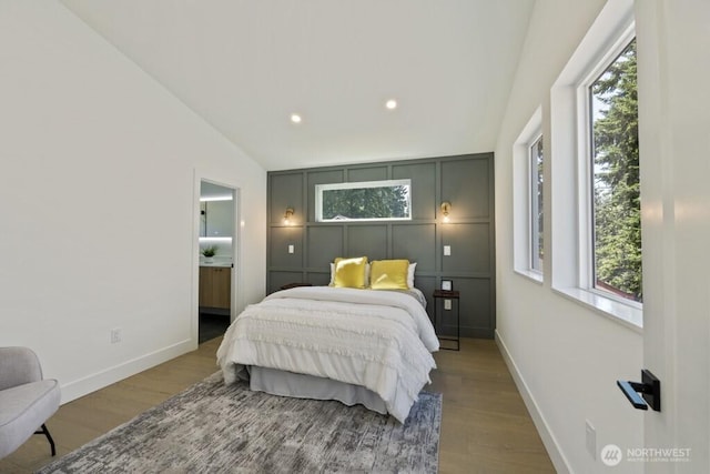 12046 5th Ave NE, Seattle, WA 98125 - bedroom featuring wood finished floors, multiple windows, recessed lighting, and ensuite bathroom