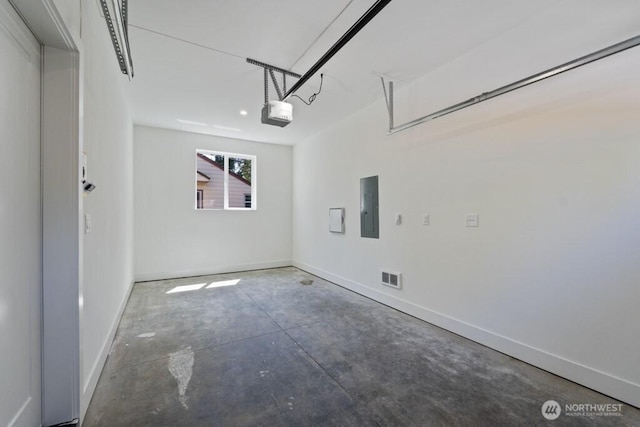 12046 5th Ave NE, Seattle, WA 98125 - garage featuring electric panel and a garage door opener