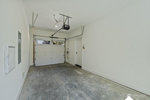 12046 5th Ave NE, Seattle, WA 98125 - garage featuring a garage door opener and baseboards